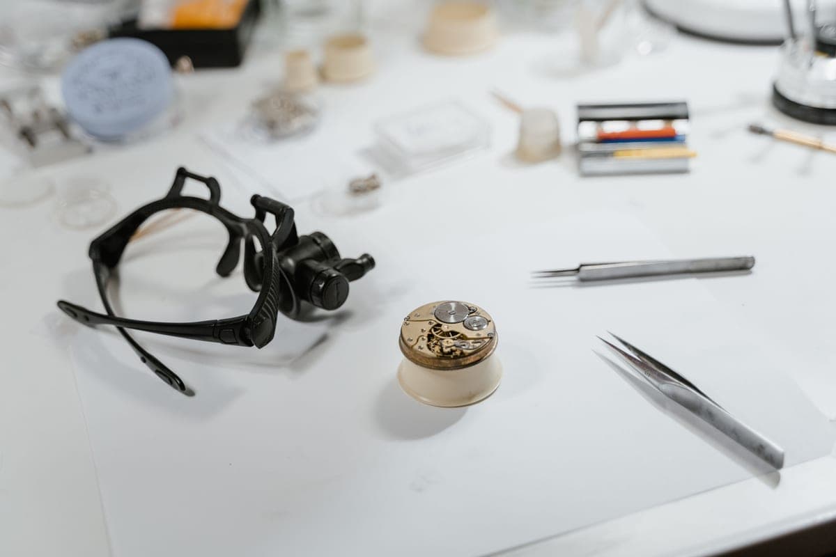 Watchmaking tools laid out on a repair bench